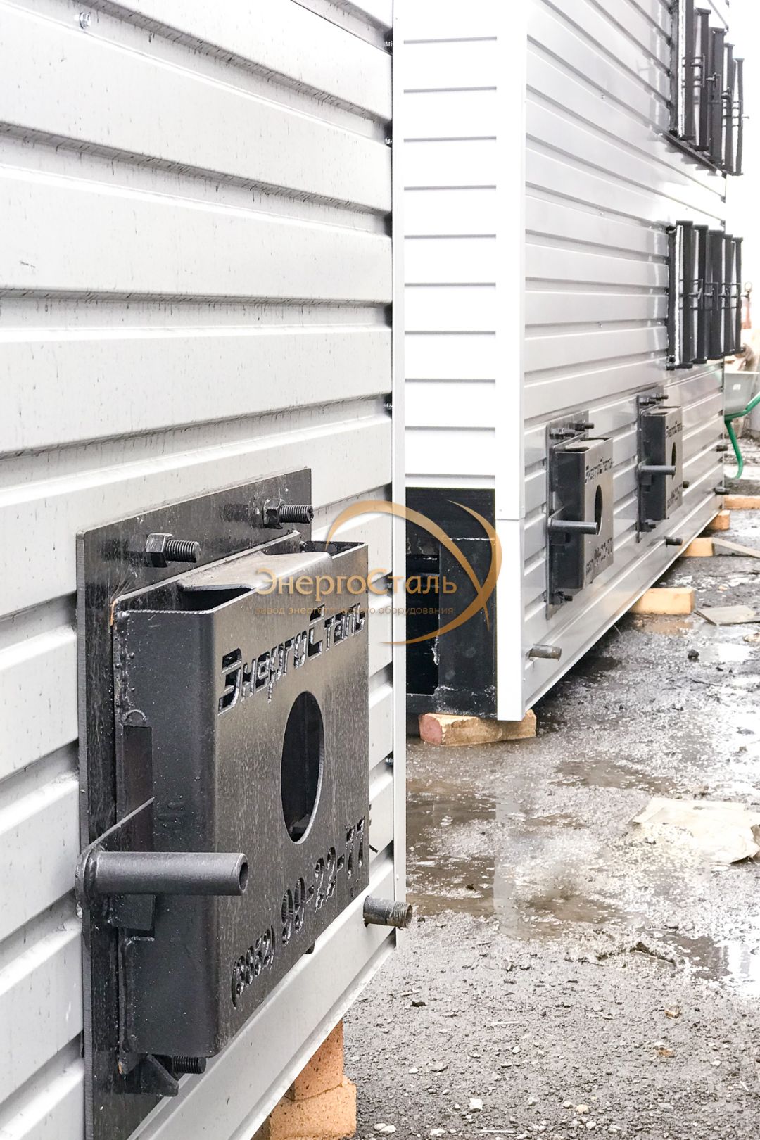 Крупный план топочной/зольной двери водогрейного котла КВр, газоплотная обшивка, ручная подача топлива.